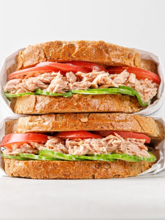 Two,Delicious,Tuna,Sandwiches,With,Tomato,And,Cucumber,In,Paper